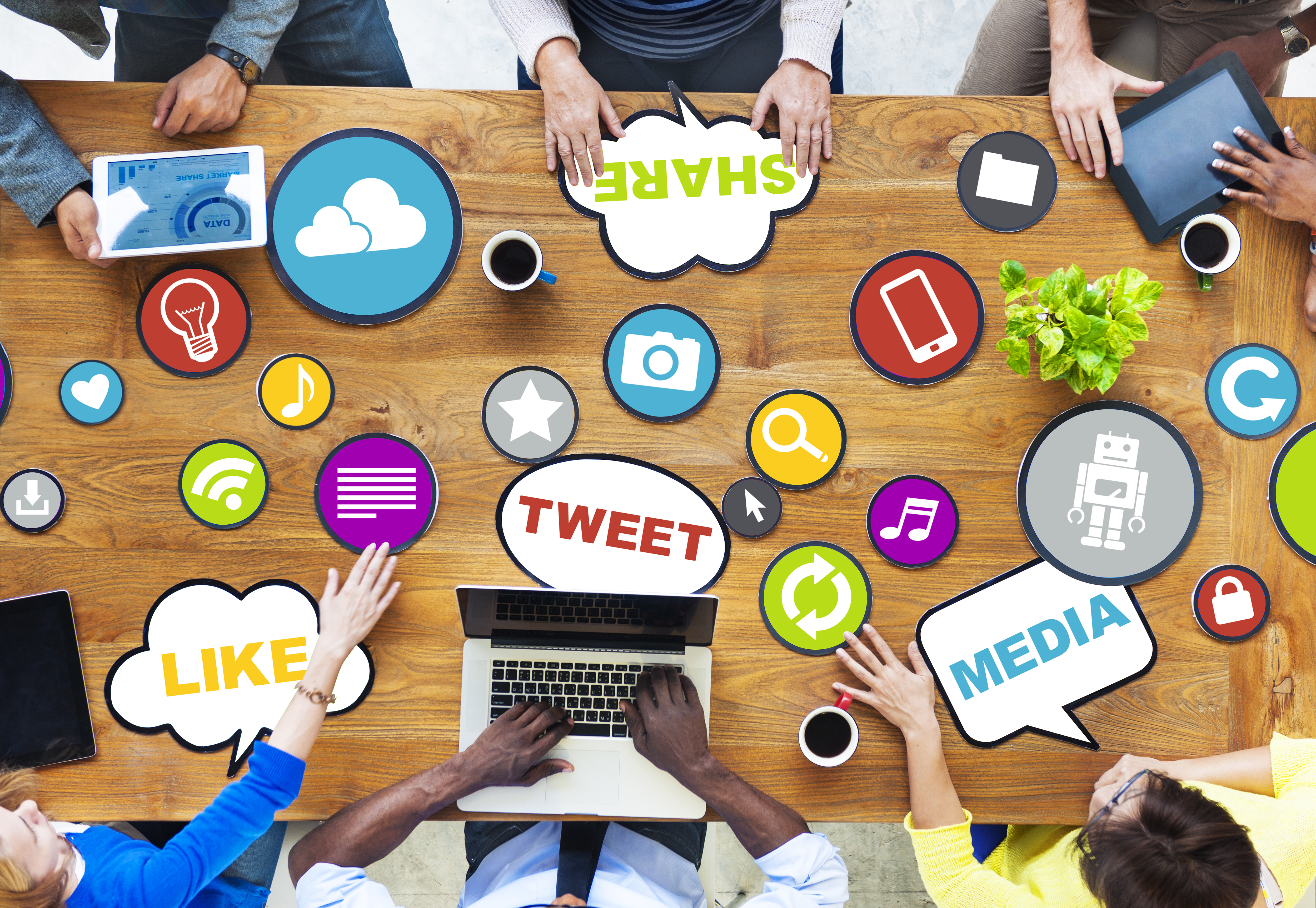 people seated around a table discuss marketing with visual aids